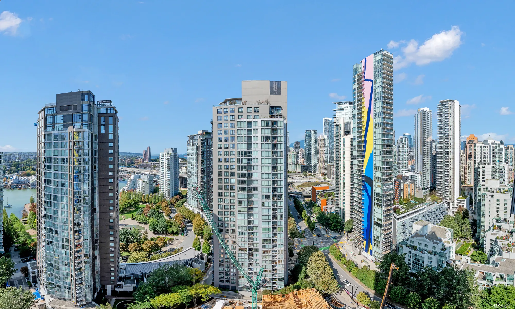 A panorama from the balcony: the towers of Yaletown, False Creek and its bridges, David Lam Park's lawns and trees, the mountains on the skyline