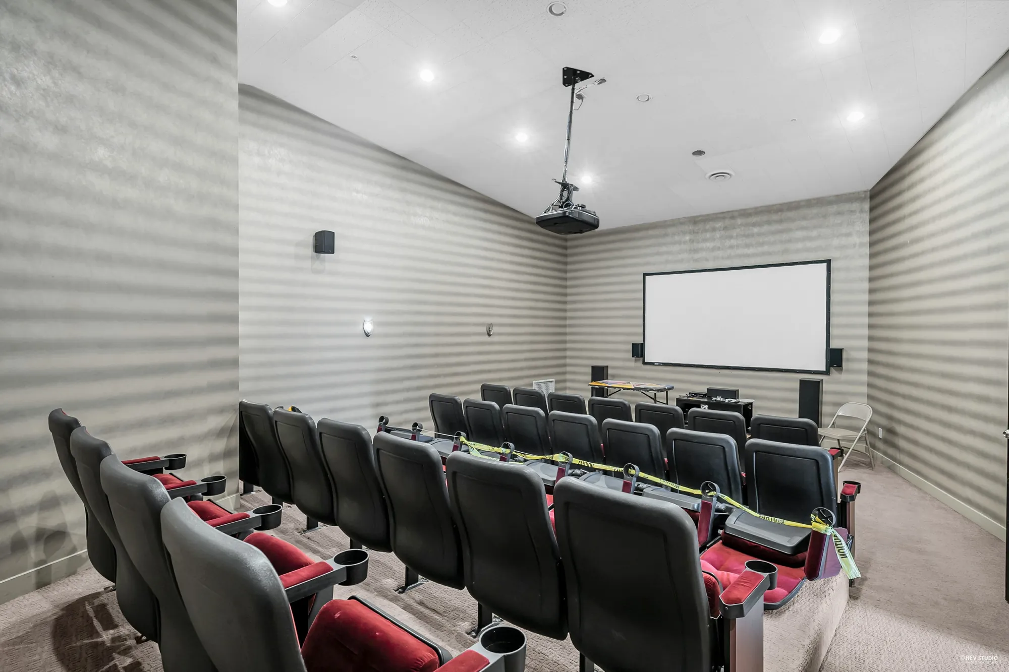 The theatre: rows of black and red seats facing a screen